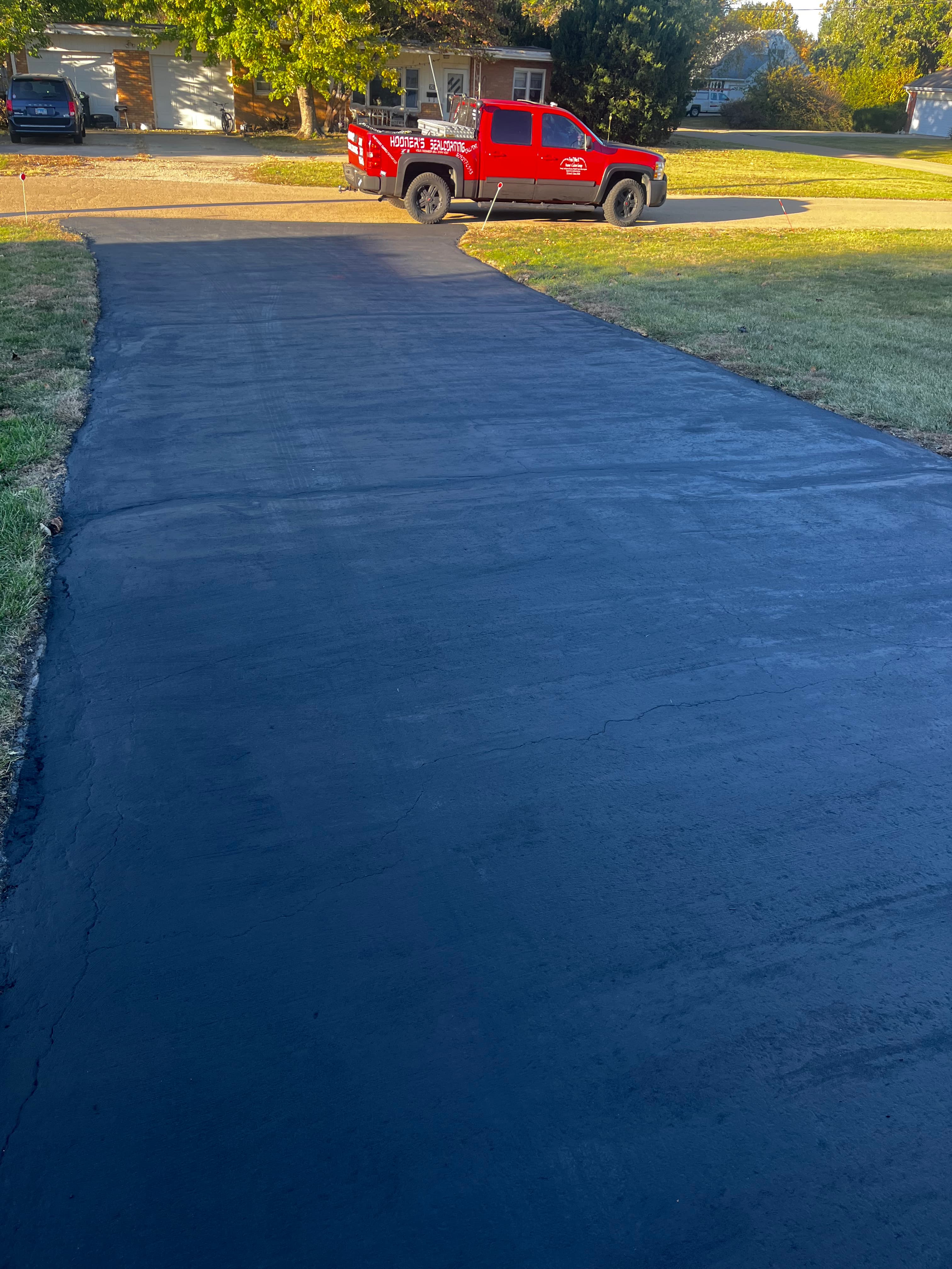 Crack repair in progress — sealed edges, full-depth crack sealing, not a surface patch