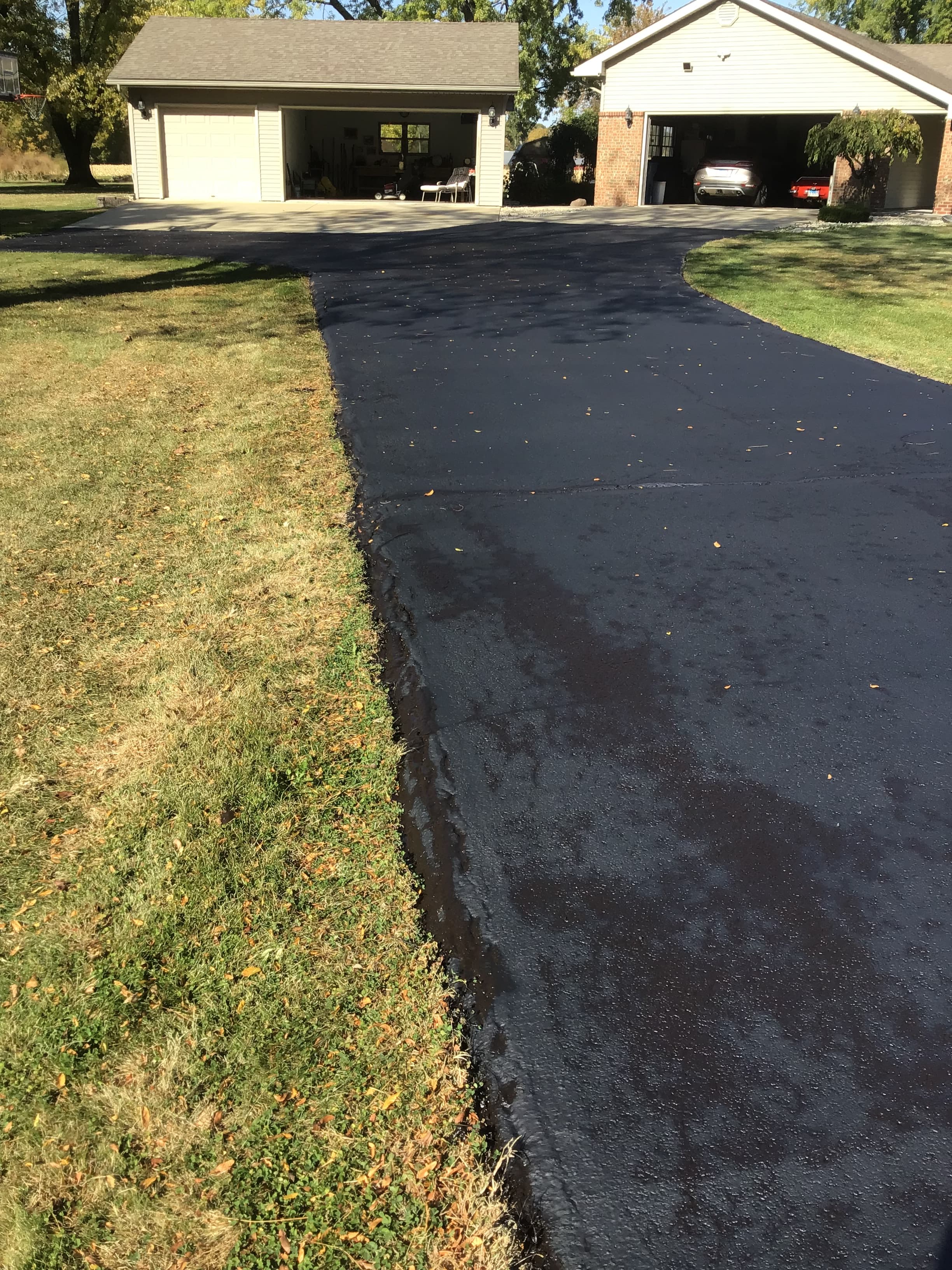Freshly sealed residential driveway by Hooners Sealcoating